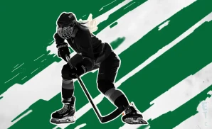 a boston pwhl ice hockey player dribling